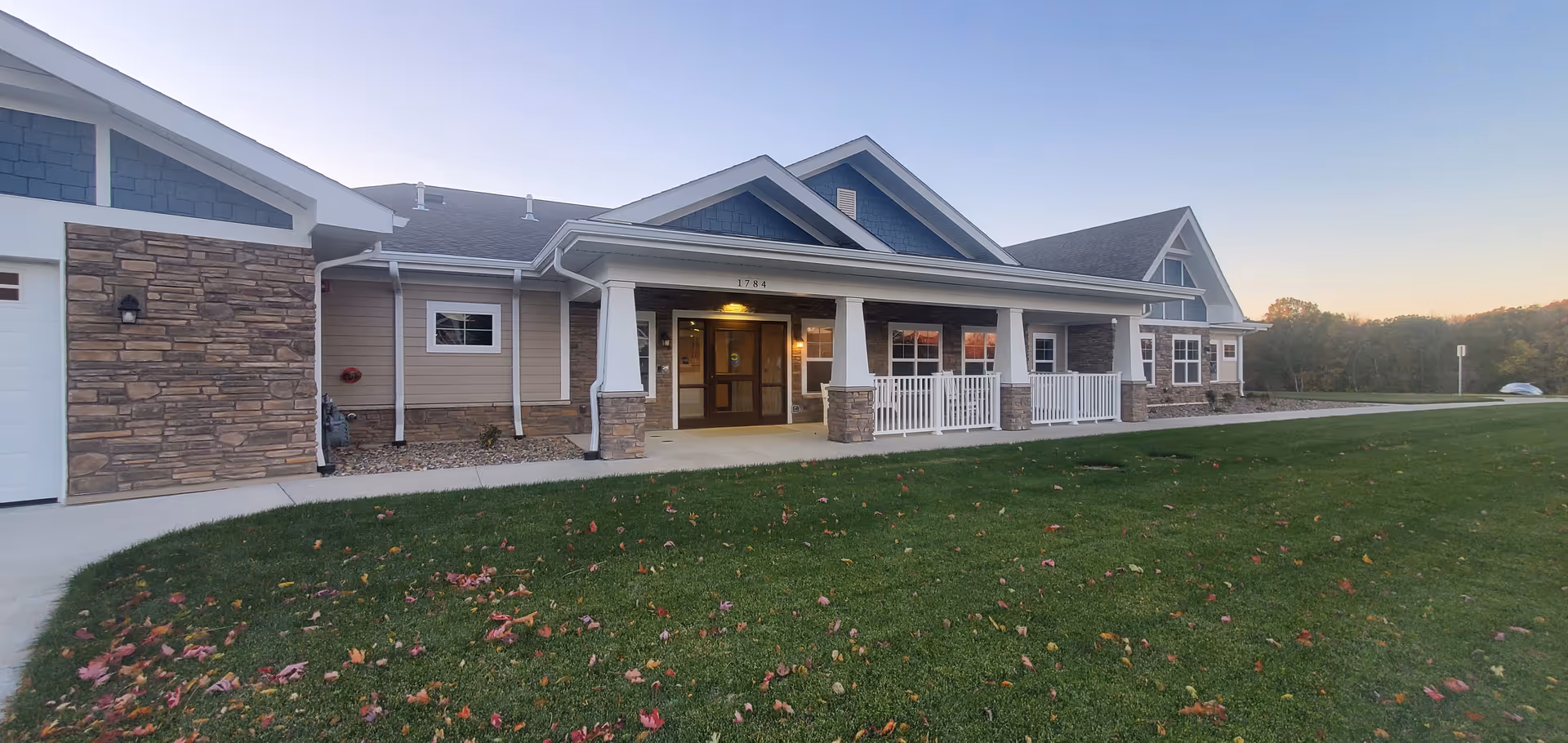 Overijssel senior living facility exterior featuring a covered front entrance and lawn.