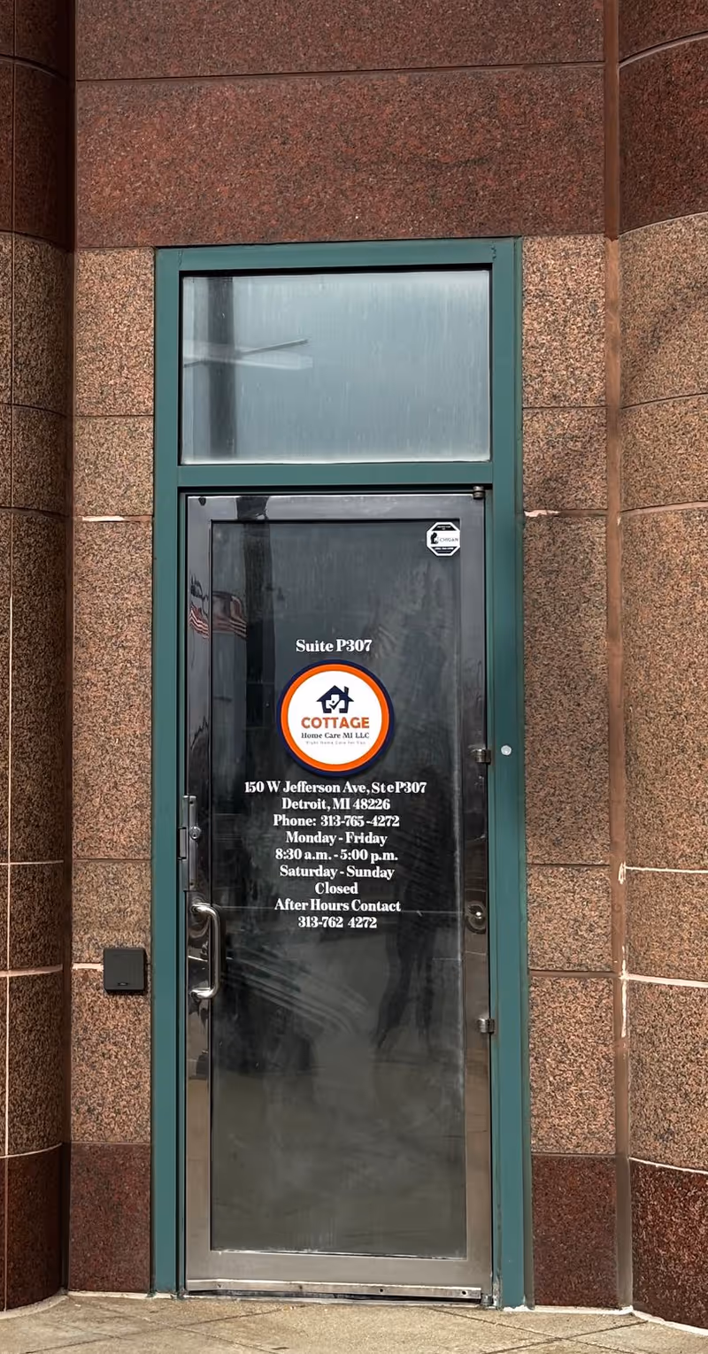 Glass door entrance labeled Cottage Home Care MI LLC on a brick exterior facade.