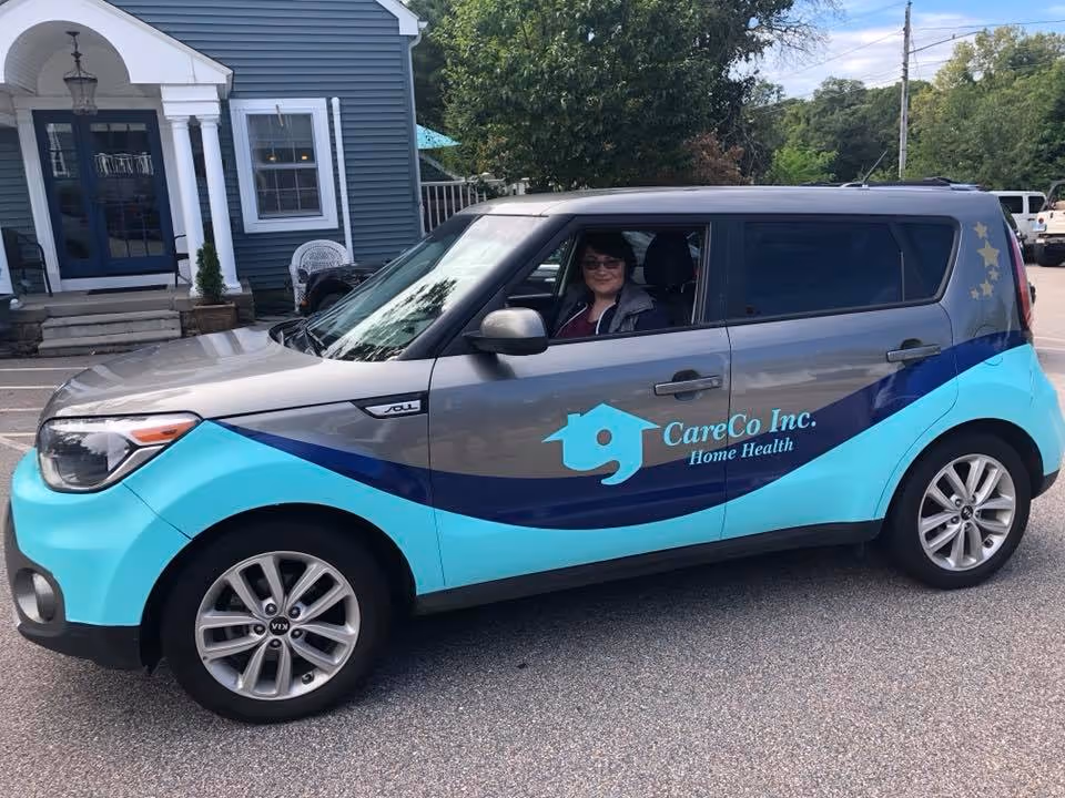CareCo Inc. home health van parked in front of a blue facility
