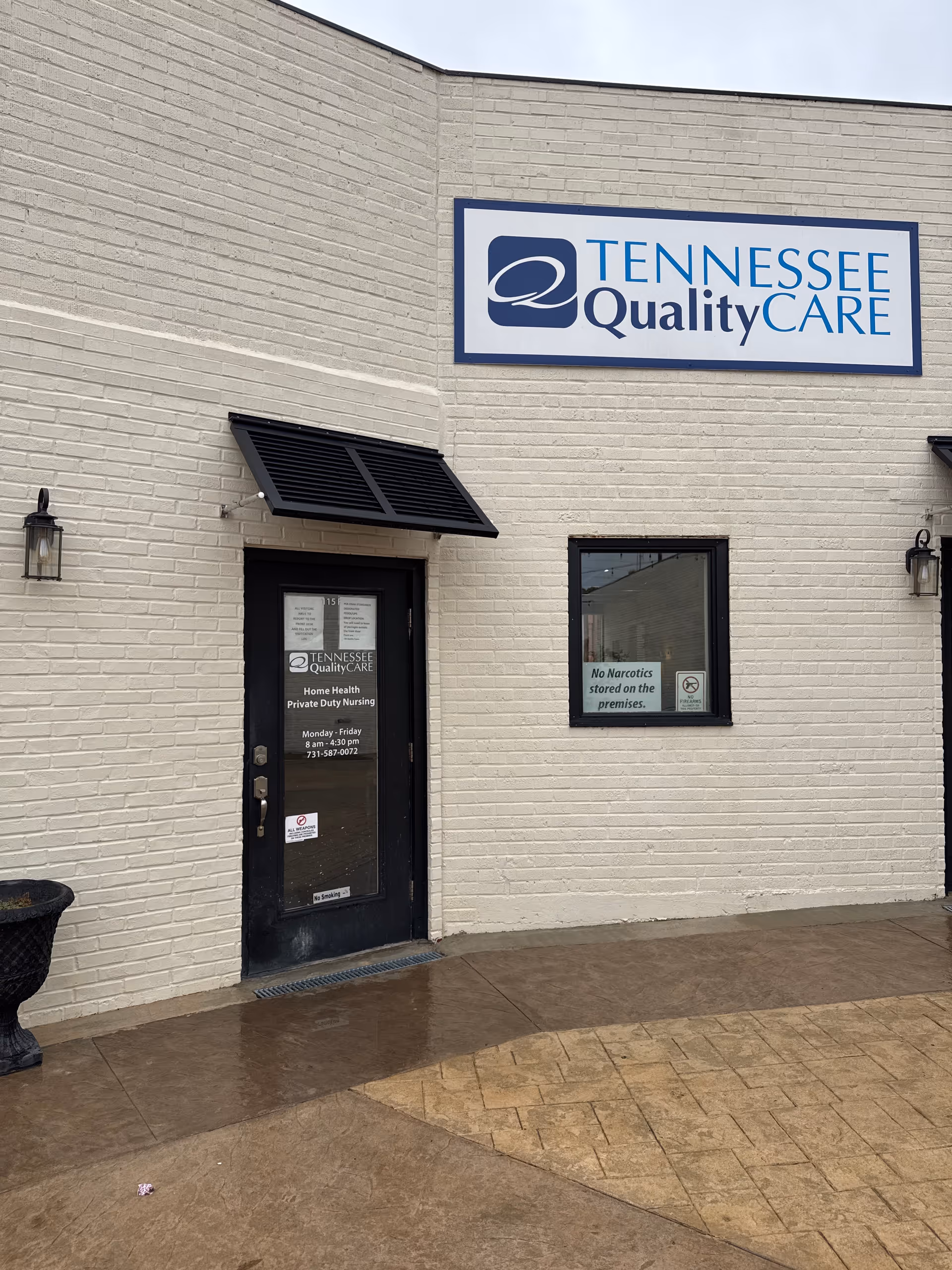 Front exterior of a Tennessee QualityCARE facility with sign, door, and window.