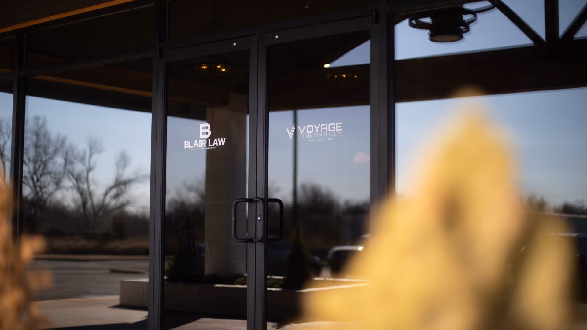 Glass entrance doors display Voyage Long Term Care logo and Blair Law branding.