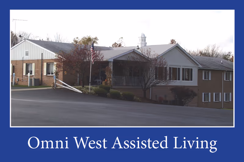 Front view of a brick assisted living facility with a blue border and white trim.