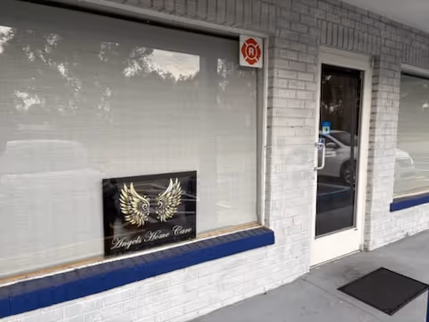 Exterior view of Angels Home Care storefront with glass door and sign.