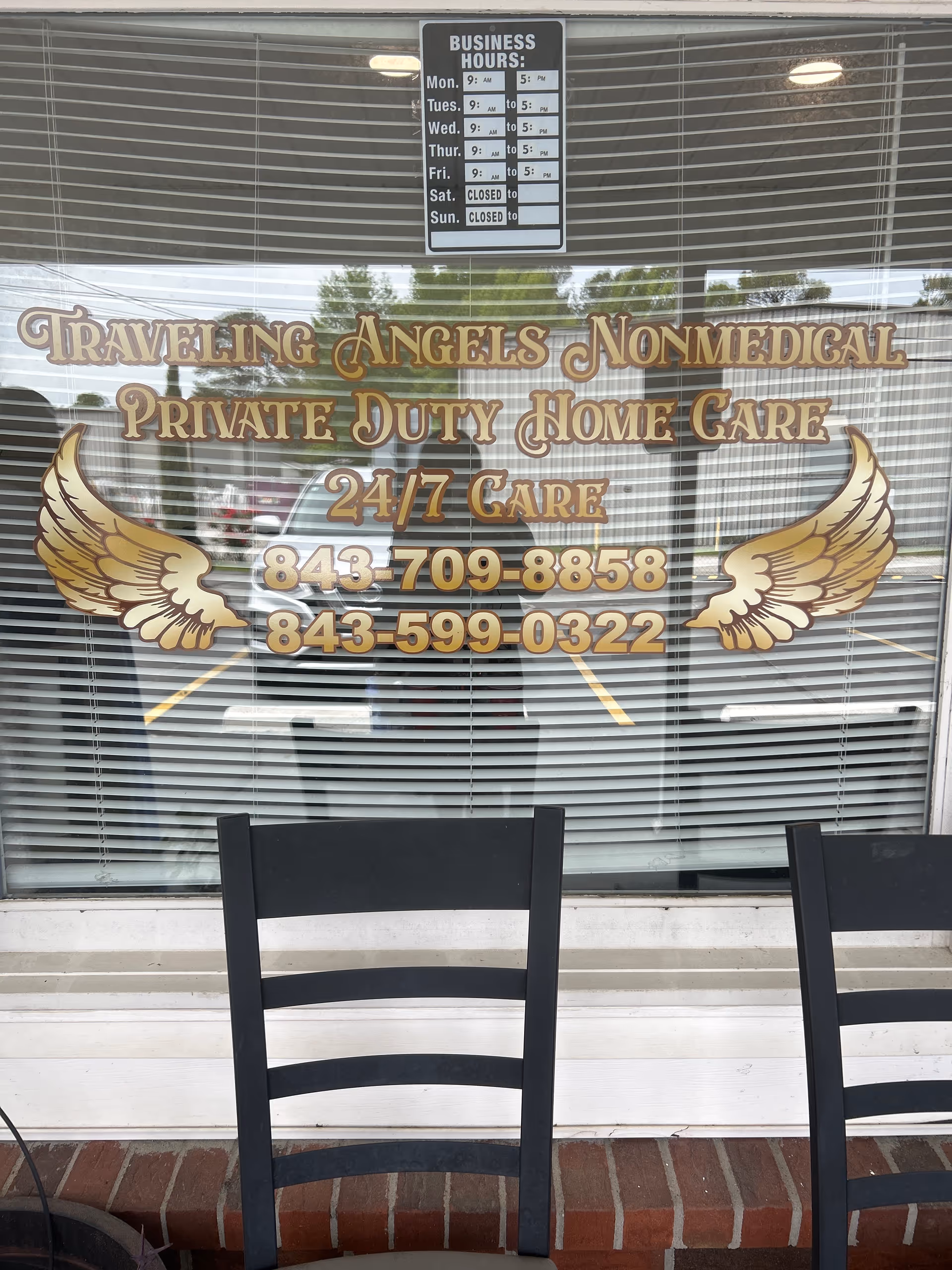 Storefront window sign for Traveling Angels Non-Medical Private Duty Home Care with wings.