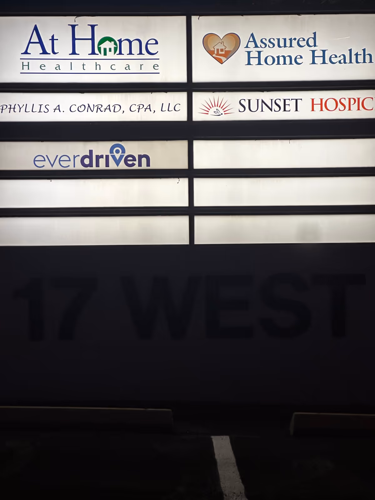 Exterior building signage displaying Sunset Hospice and other healthcare logos.