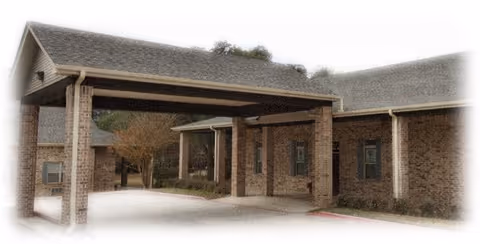 Brick building with a covered entrance and drive-through drop-off area.