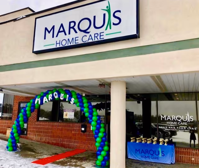 Marquis Home Care facility exterior featuring a balloon arch at the entrance.