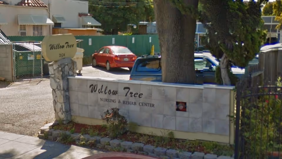 Exterior view of Willow Tree Nursing and Rehab Center sign at the entrance.