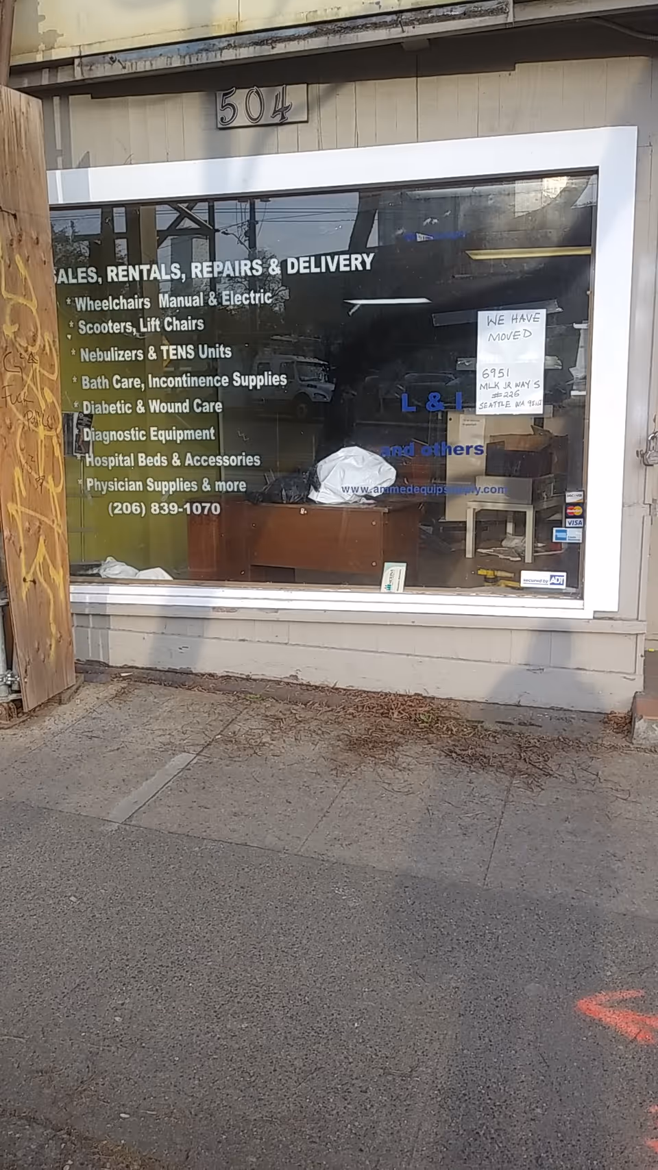 Front storefront displaying window signage for sales, rentals, repairs, and delivery of medical equipment.