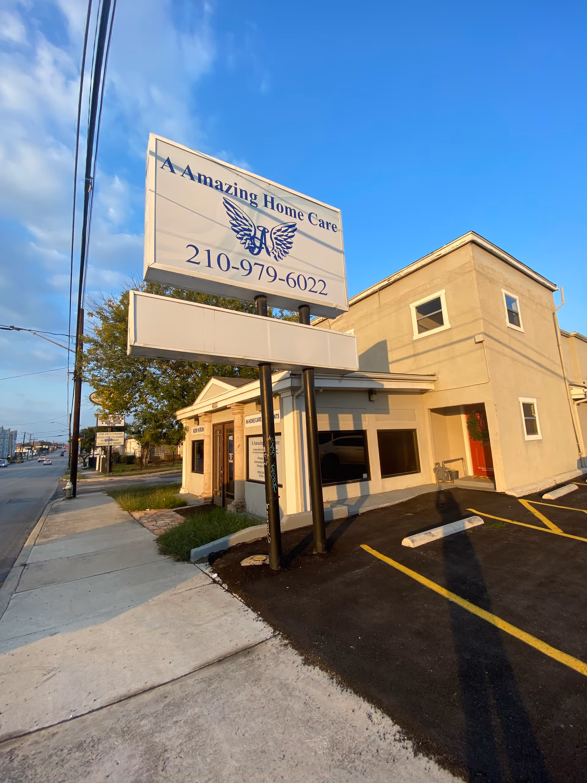 Exterior view of A Amazing Home Care building with large sign and parking lot.