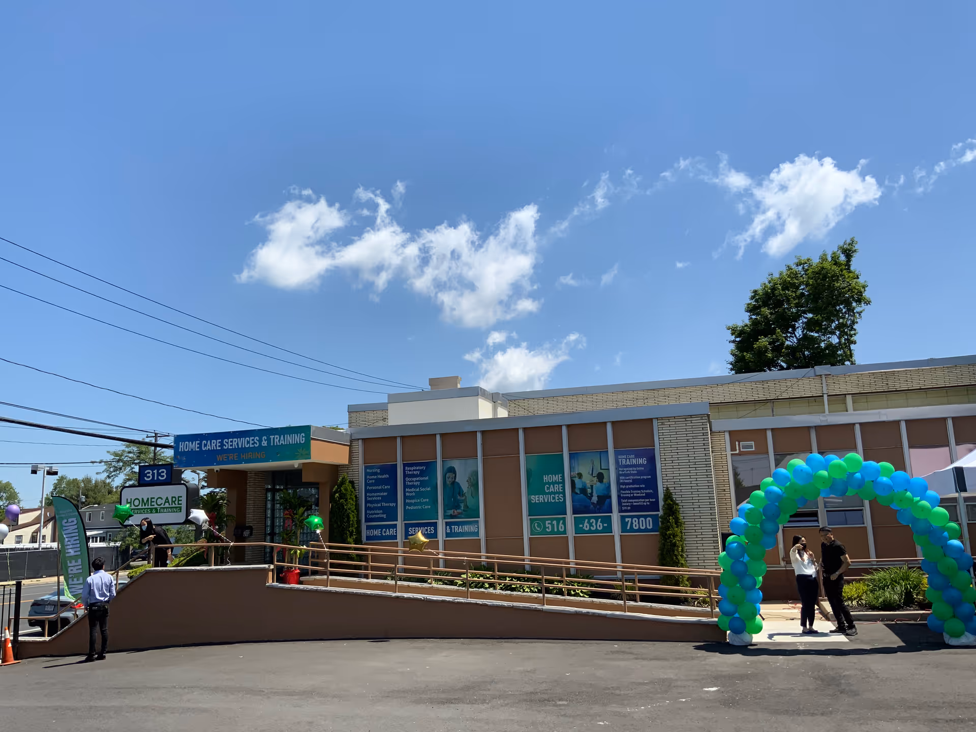 Exterior view of ABI Health Care building with balloon arch and signage.