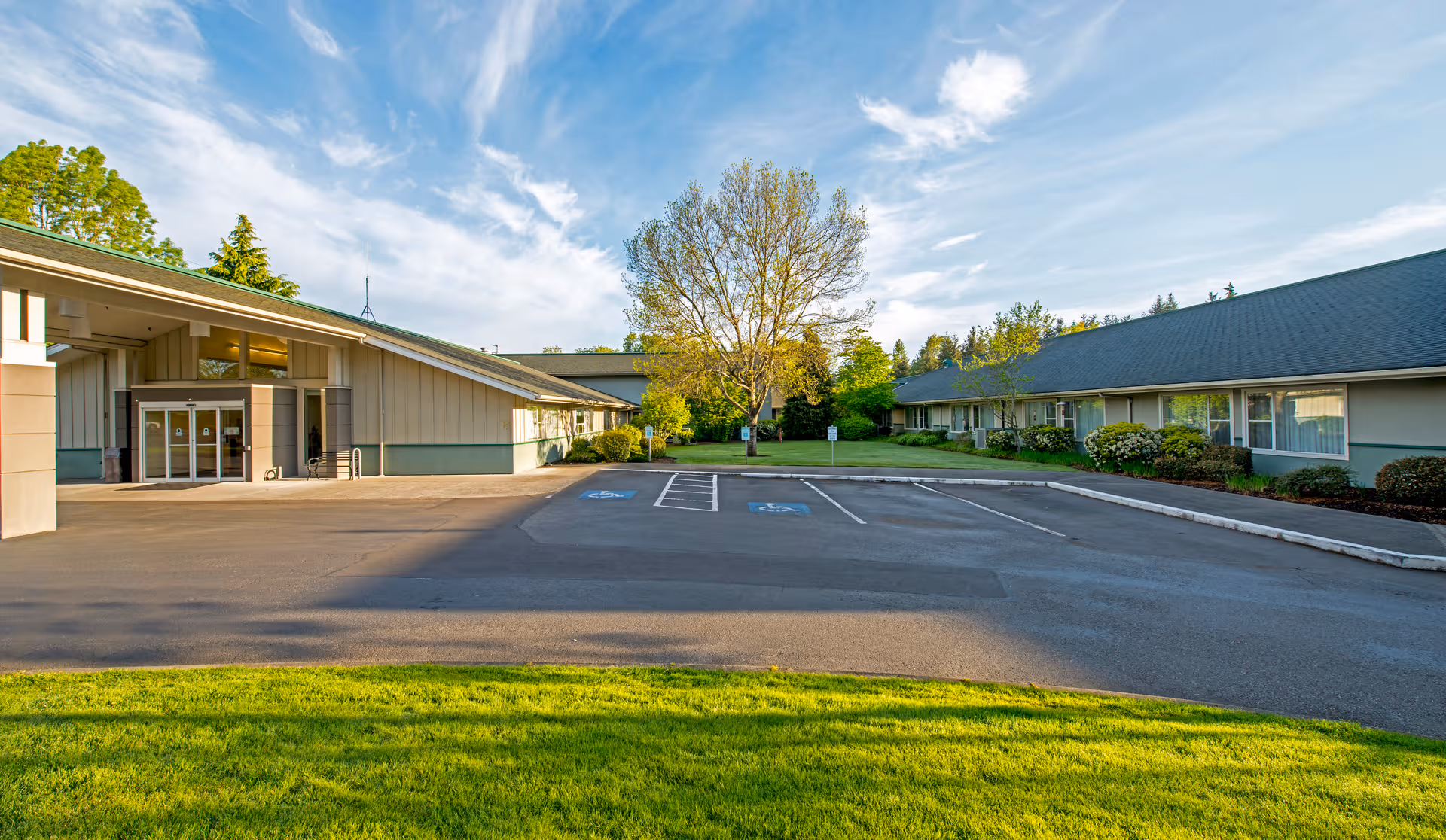 Exterior view of Wesley Des Moines Rehabilitation and Care Center with front entrance and parking.