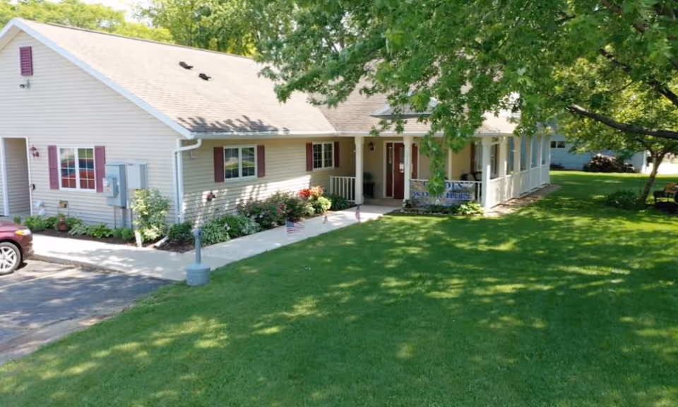 Exterior view of Aperion Care Lincoln, a single-story building with a porch and well-kept lawn.
