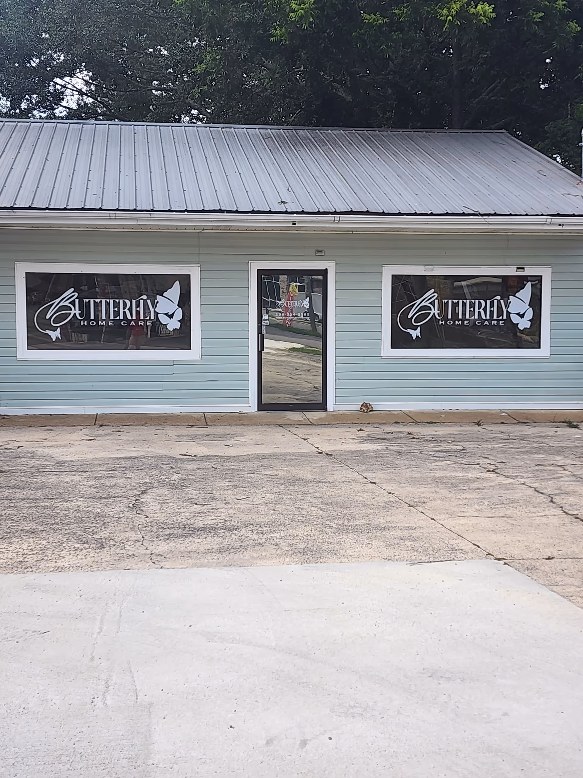 Light blue building exterior with Butterfly Home Care sign on front windows.