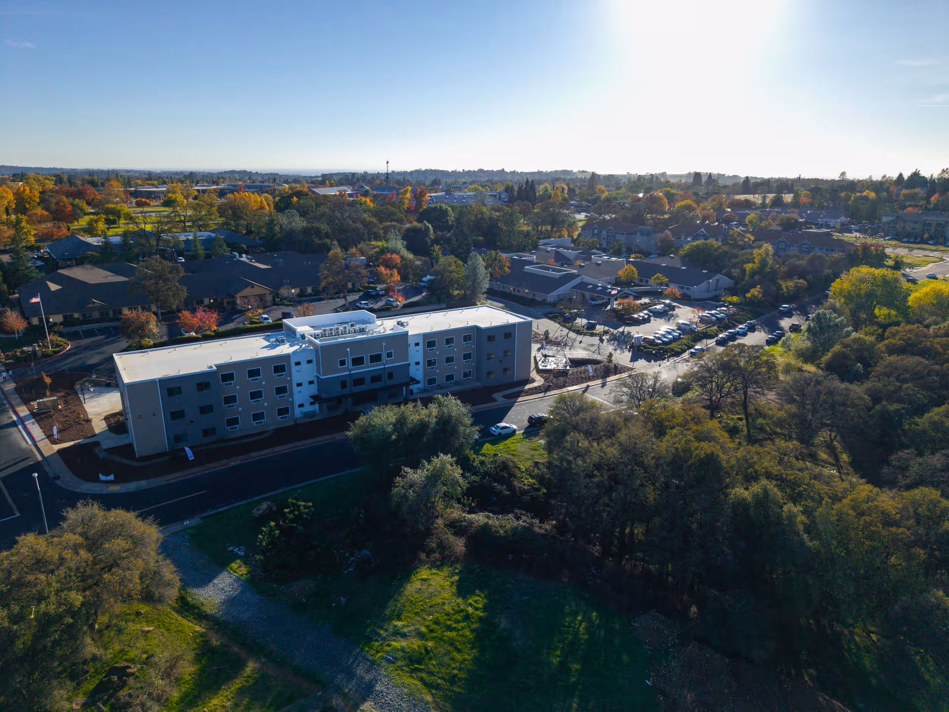 Aerial view of Siena Skilled Nursing & Rehabilitation Center with surrounding trees and parking.