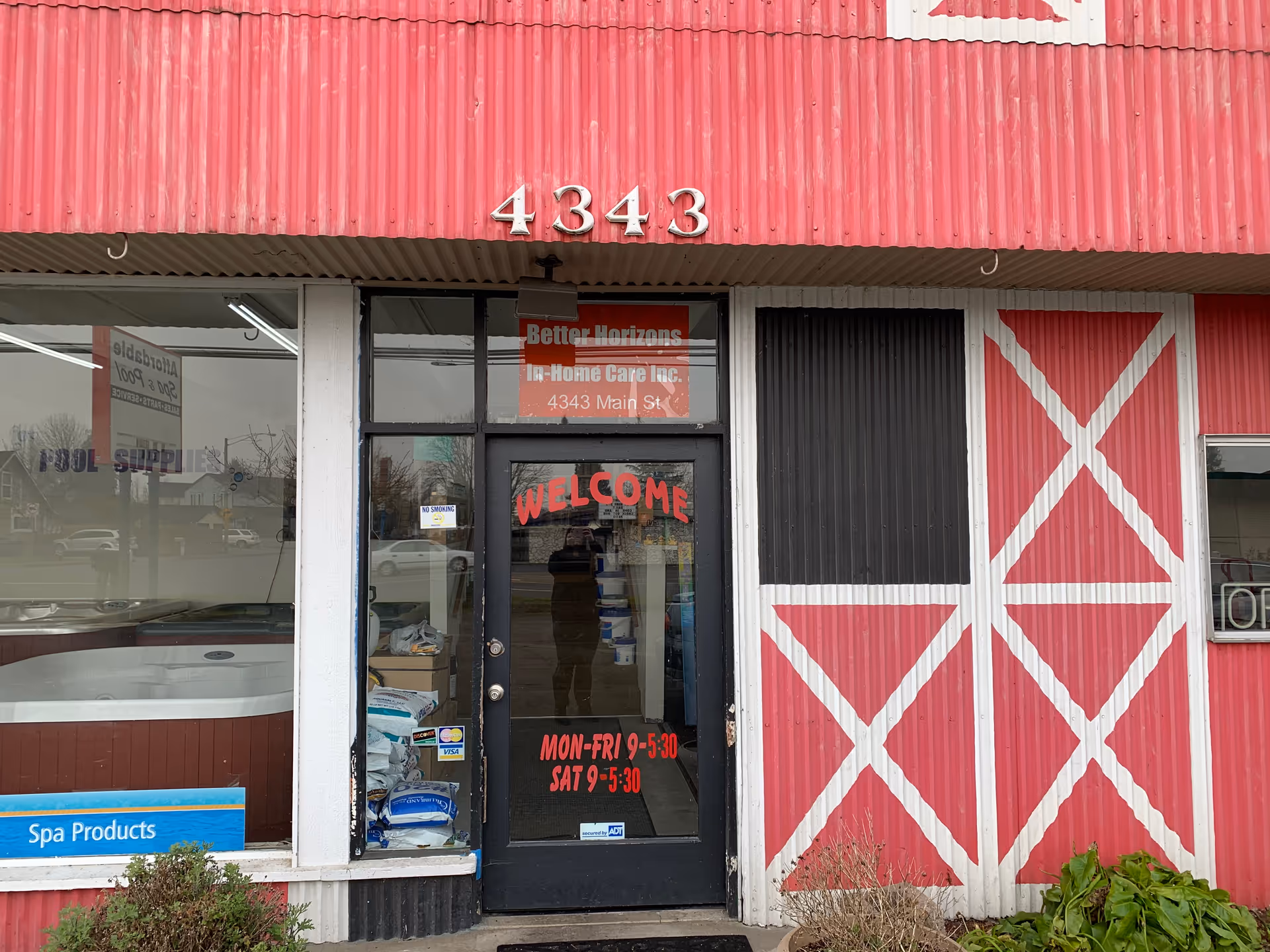 Exterior pink storefront of Better Horizons In-Home Care with welcoming door.