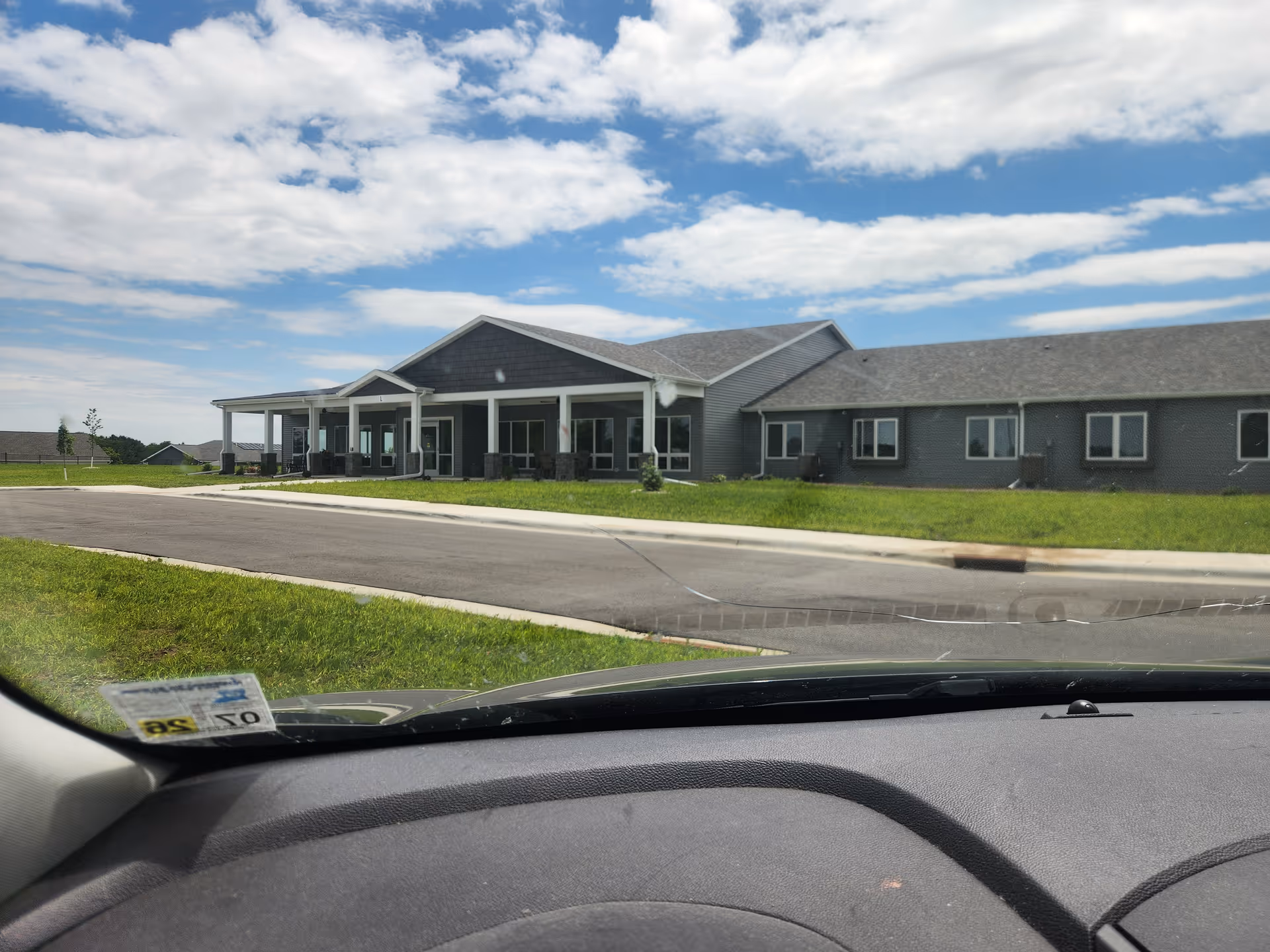 Front view of Aase Haugen Homes, a single-story senior living facility with a covered entrance.