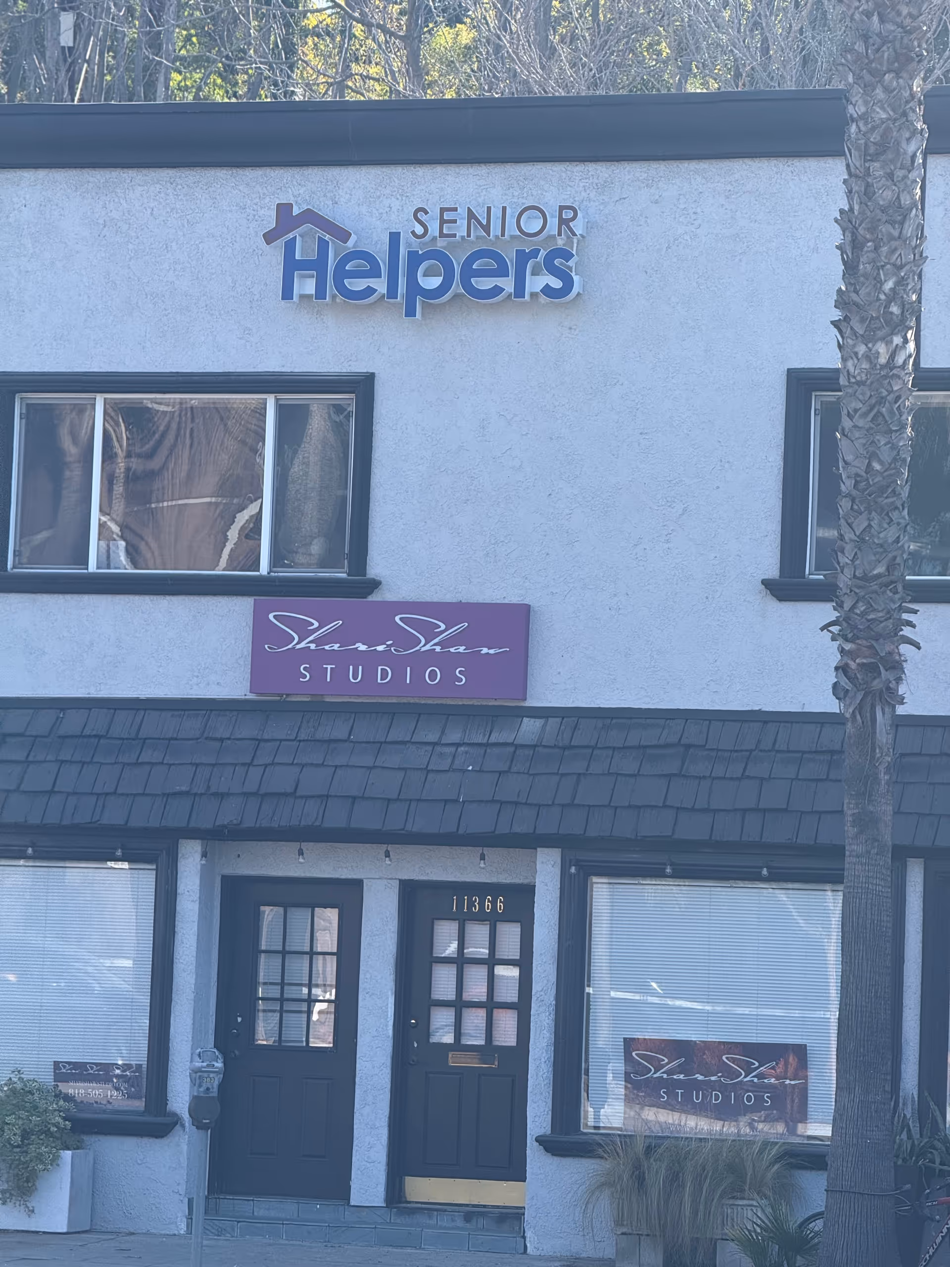 Exterior of a building with Senior Helpers North Valley sign and Studios storefront.