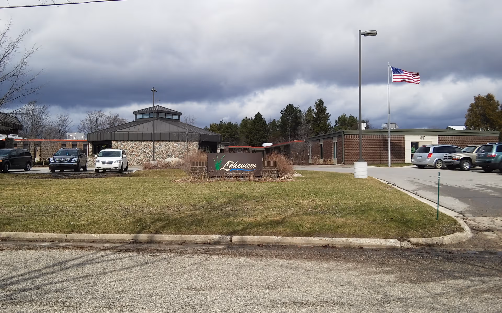 External view of Lakeview senior care center with parking and American flag.