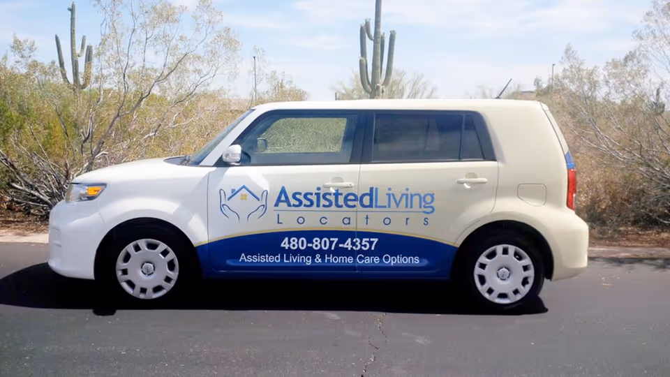 White car with Assisted Living Locators branding parked on a desert roadside