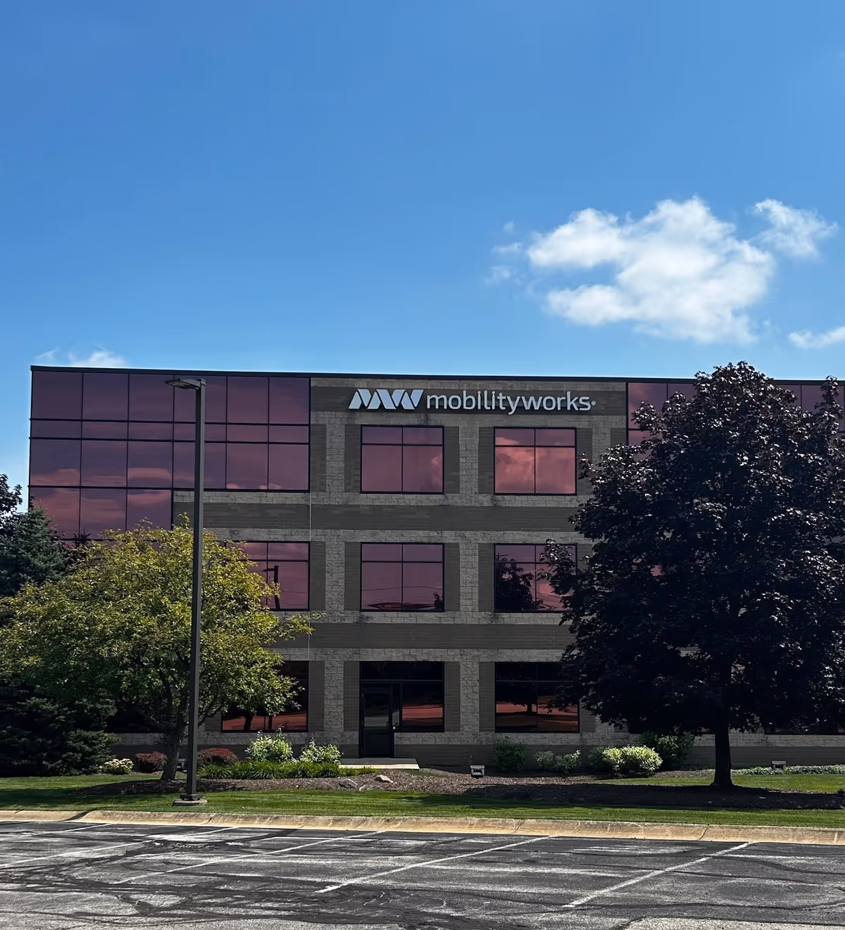 Office building exterior with MobilityWorks sign and red-tinted windows.
