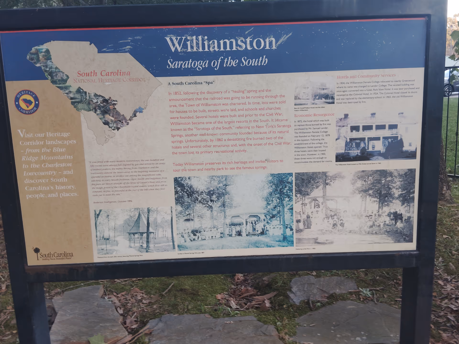 Outdoor informational signboard with historical text and vintage photographs.