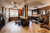 Spacious interior common area with salon chairs, mirrors, and seating for residents.