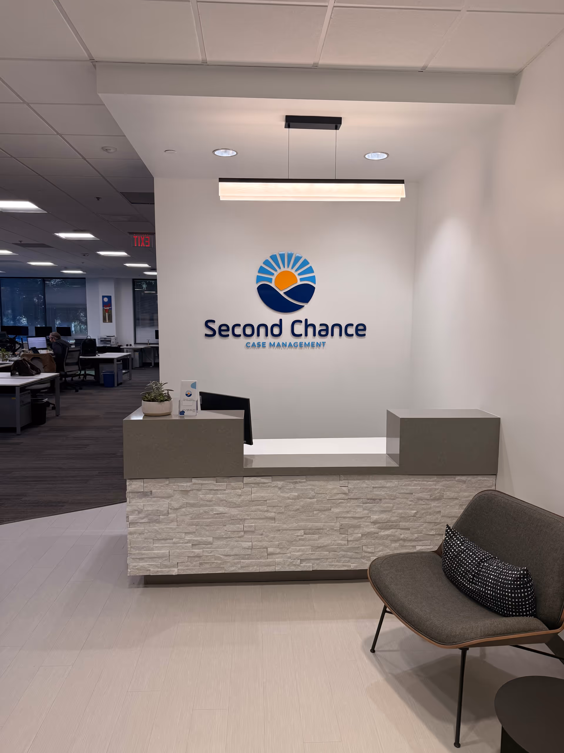 Modern reception area with Second Chance Case Management logo and seating.