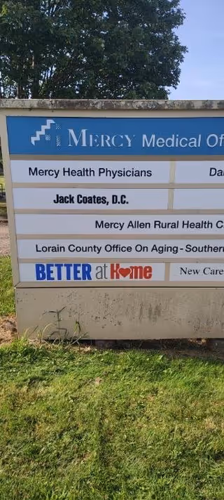 Outdoor signboard advertising Better At Home and Mercy Medical Office.