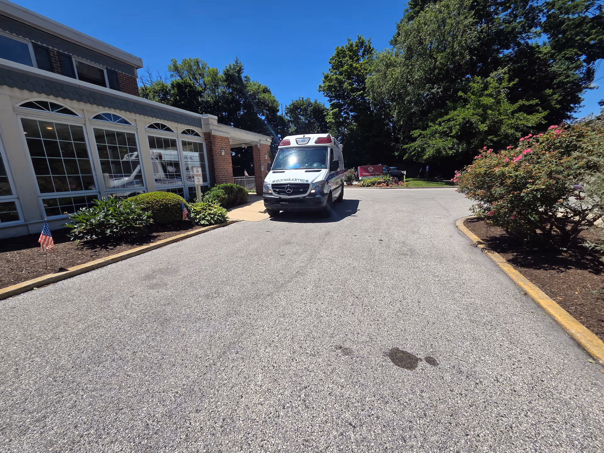 Ambulance parked in the driveway near the Rosemont Care & Rehabilitation Center entrance.
