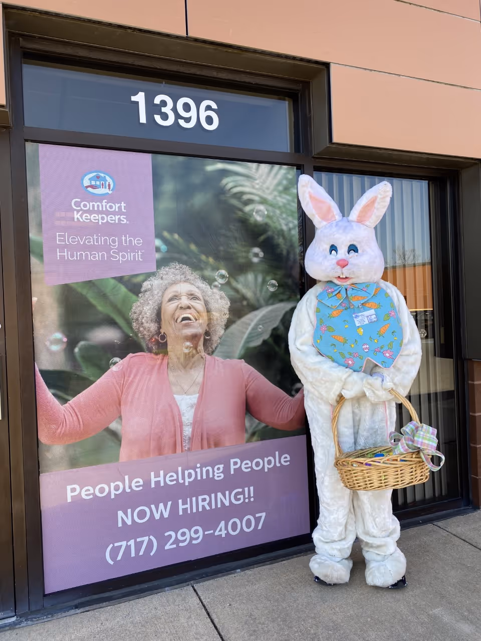 Exterior storefront of Comfort Keepers Lancaster with a bunny mascot beside the entrance.