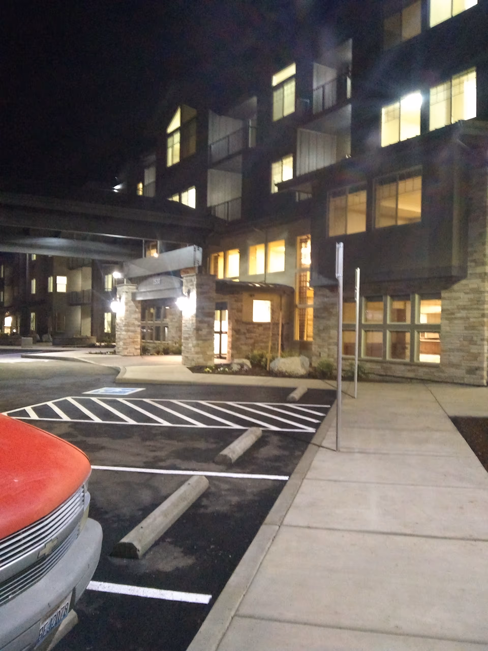 Night exterior view of Bonaventure of Medford building with parked car and lit entrance.