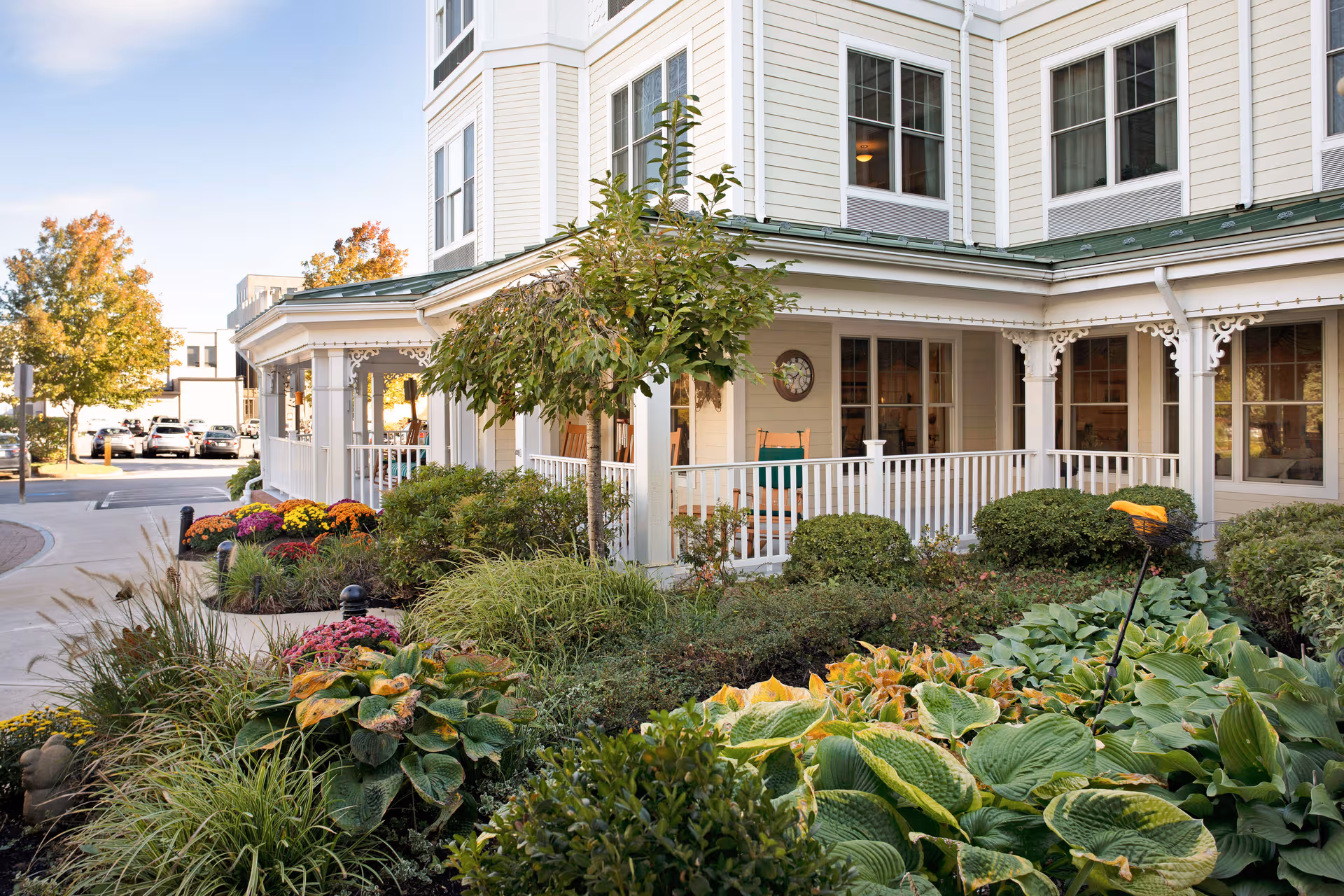 Sunrise of Braintree exterior with a white porch and colorful garden landscaping.