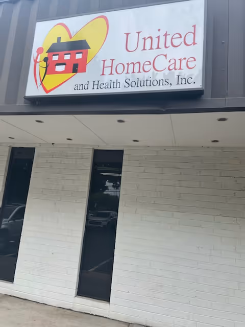 Exterior of a facility with a United HomeCare sign mounted on a brick wall.
