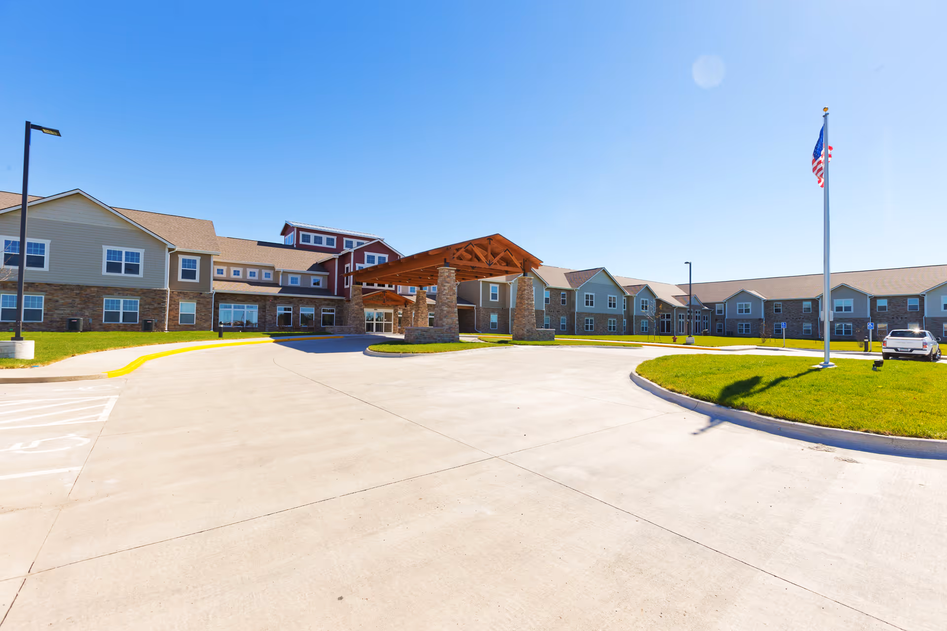 Exterior view of Prairie Vista Village featuring the entrance canopy and flagpole.