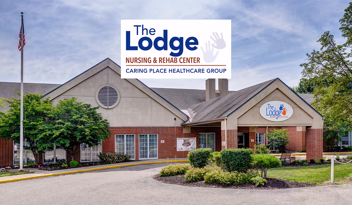 Exterior view of The Lodge Care Center with landscaping and entrance.