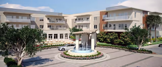 Exterior view of Inverness Rehab facility with a central fountain and landscaped courtyard.