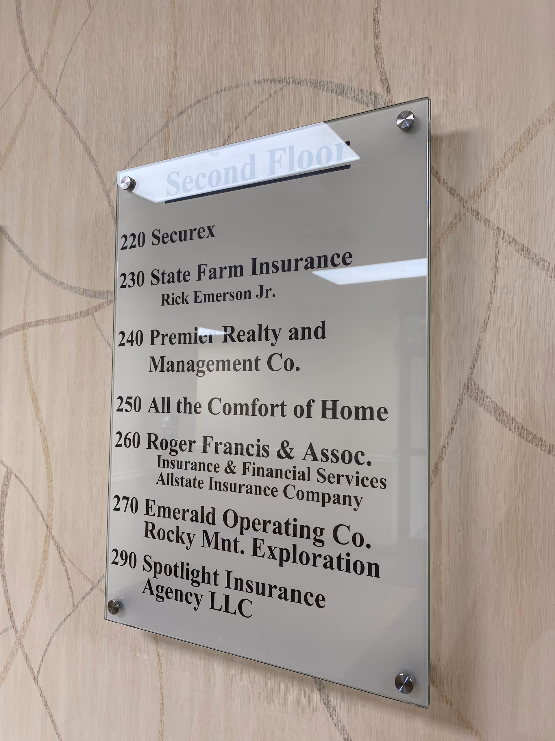Interior wall directory plaque listing suite numbers and company names