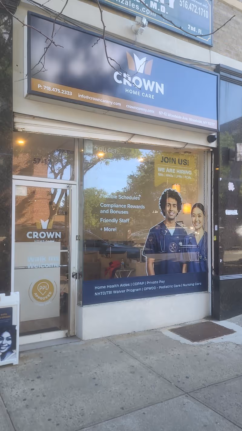 Front of Crown Home Care storefront with large sign and window display