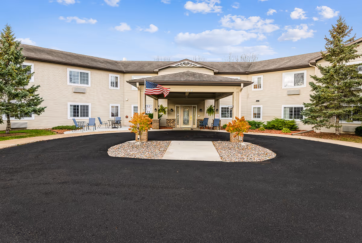 Exterior view of Oak Gardens Place with circular drive, entry, and outdoor seating.