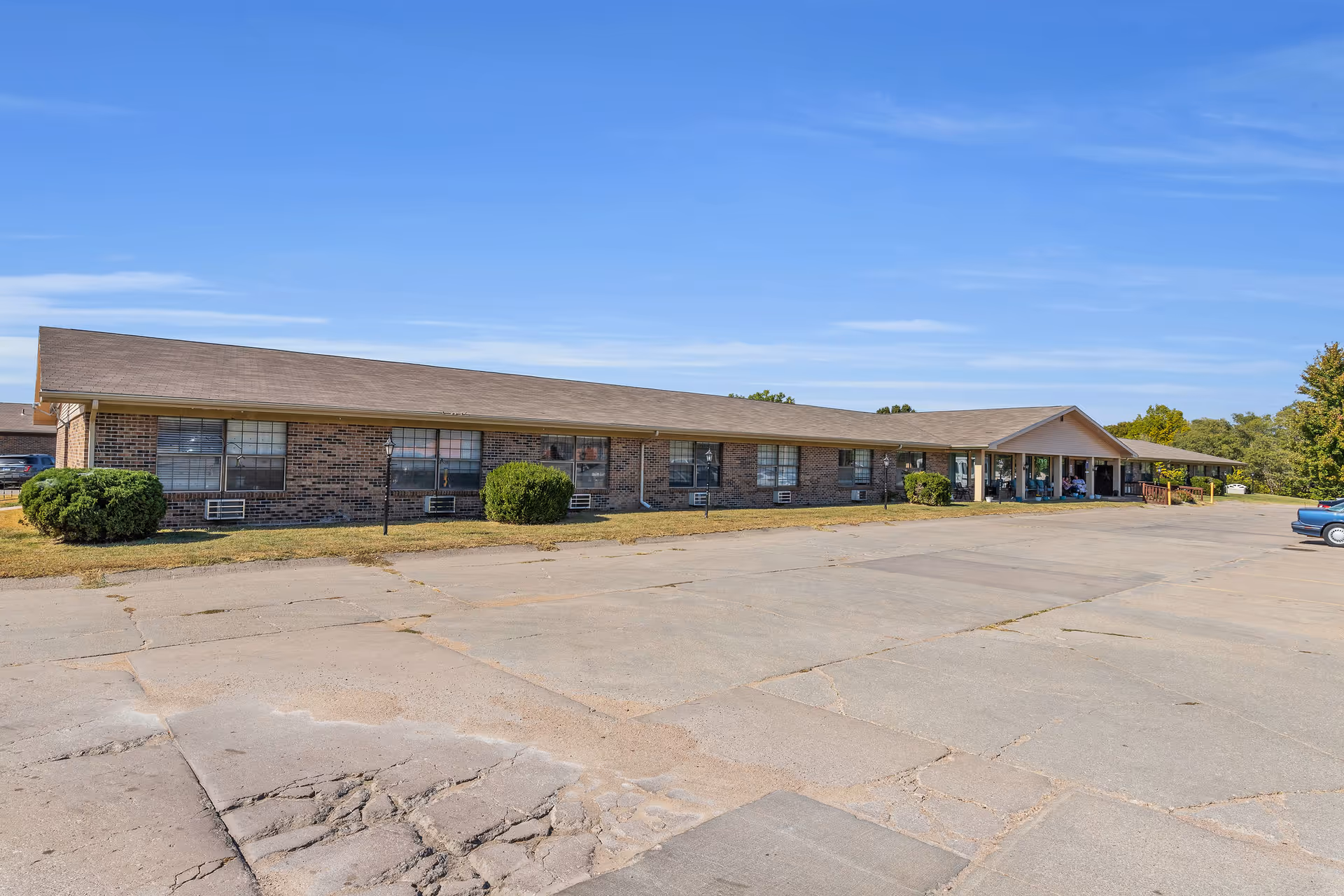 A single-story brick health care center with a front entrance and parking lot.