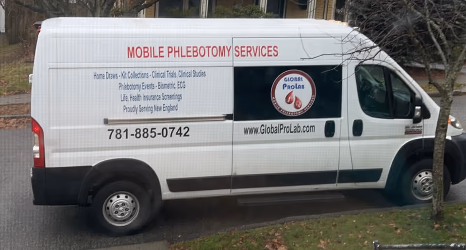 White mobile phlebotomy van parked outdoors with Global ProLab branding and contact info.