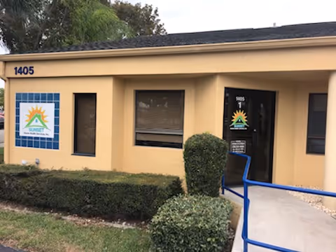Exterior view of Sunset Home Health Services building with sign, entrance, and landscaping.