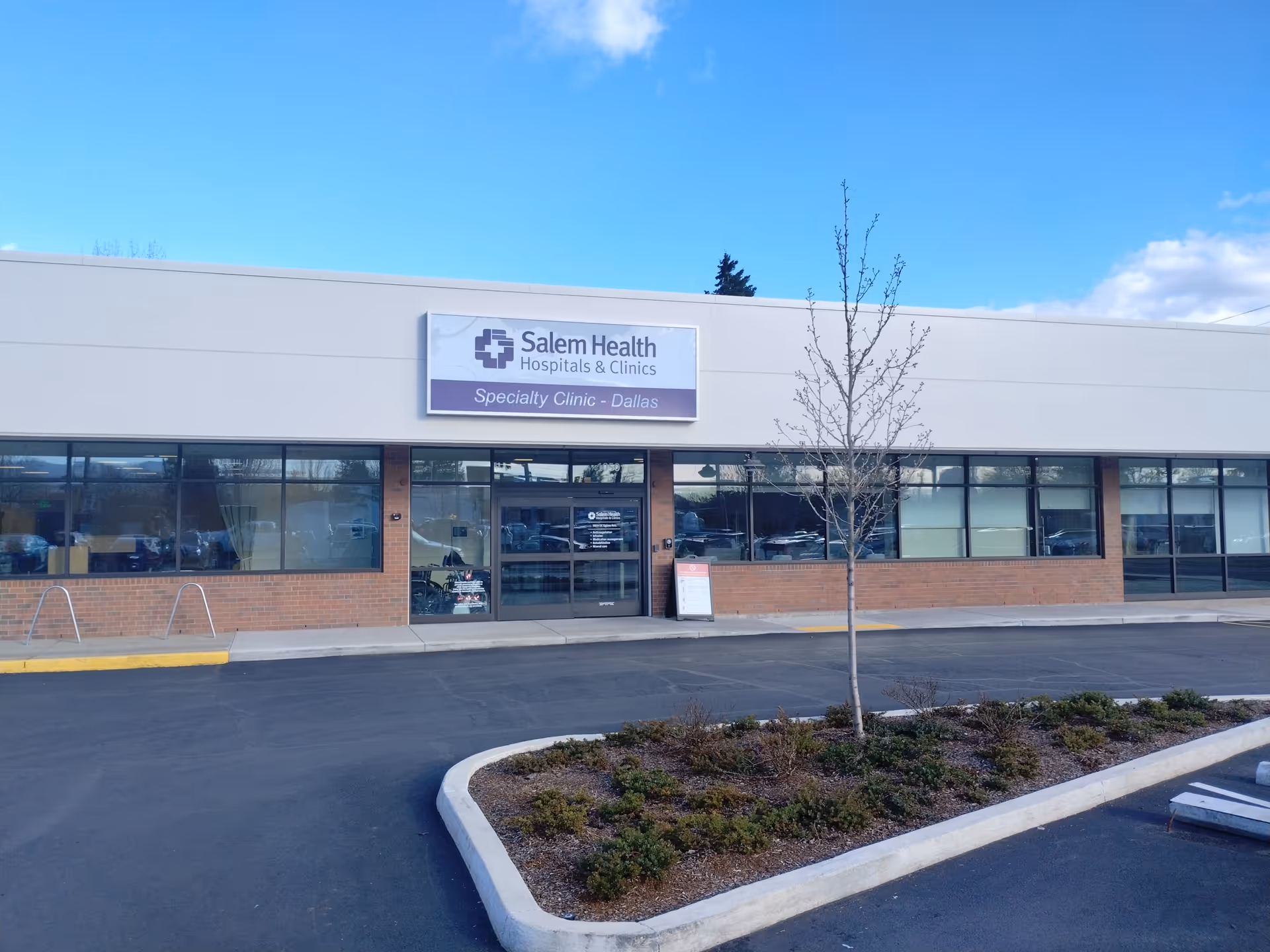 Exterior view of Salem Health Rehabilitation Services Dallas building with sign and parking lot.