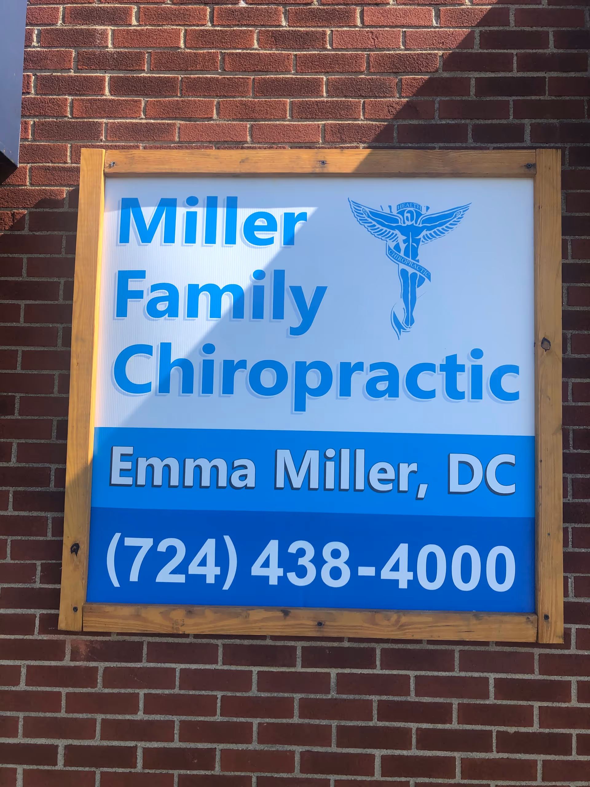 Exterior brick wall featuring a large Miller Family Chiropractic sign.
