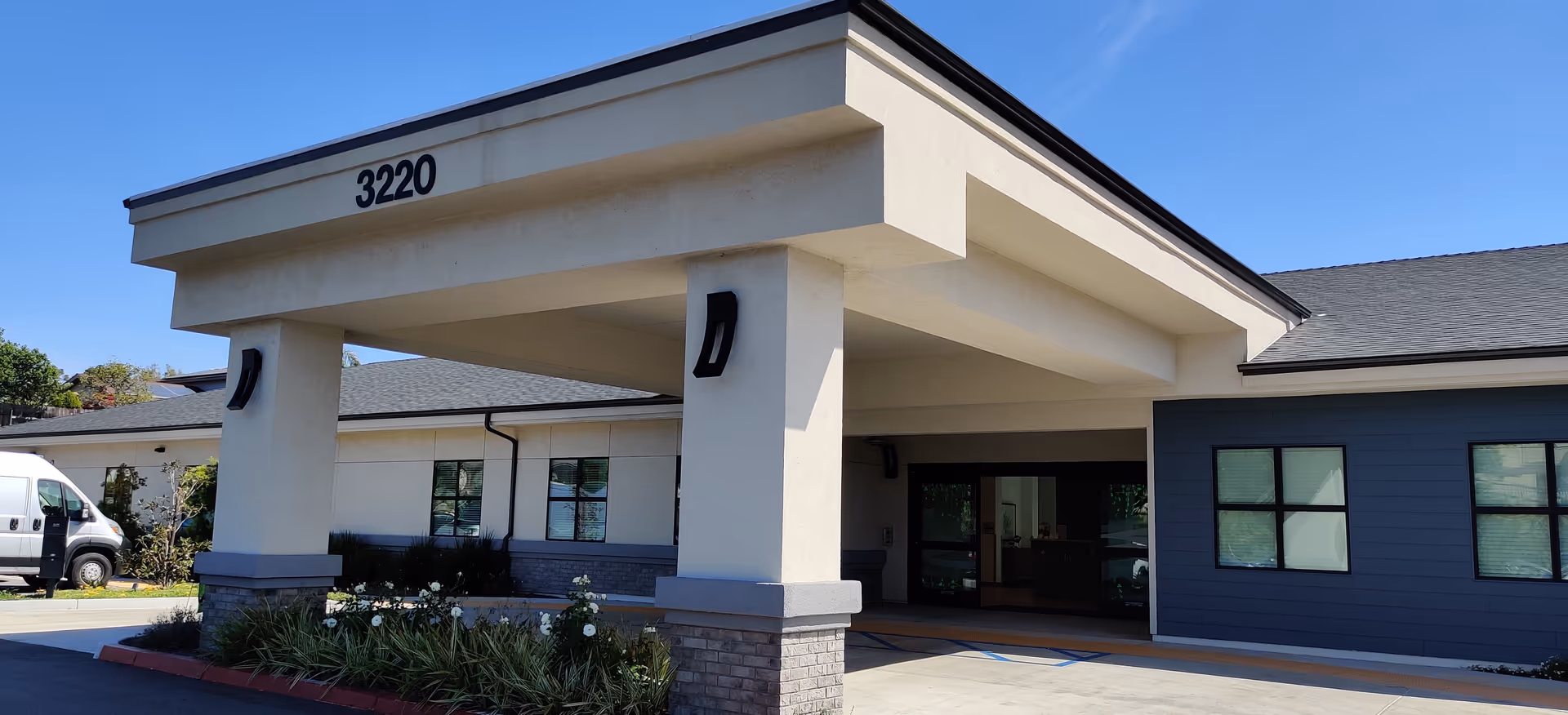 Exterior view of Pacific Villas Post Acute entrance with a covered porte-cochère.