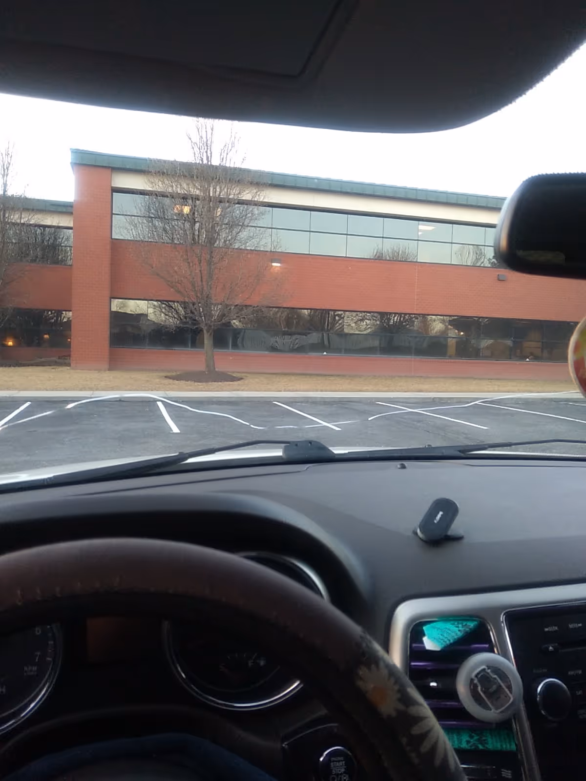 Exterior view of Heritage Communities building with brick facade and parking lot.