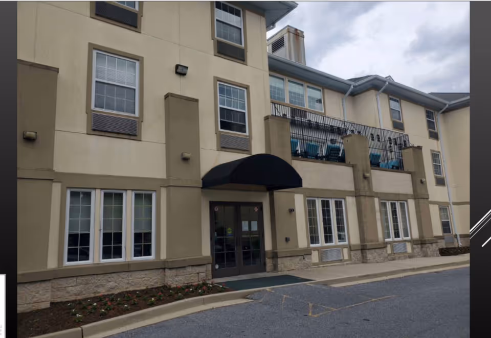 Exterior view of Aventura at the Heights showing entrance, windows, and balconies.