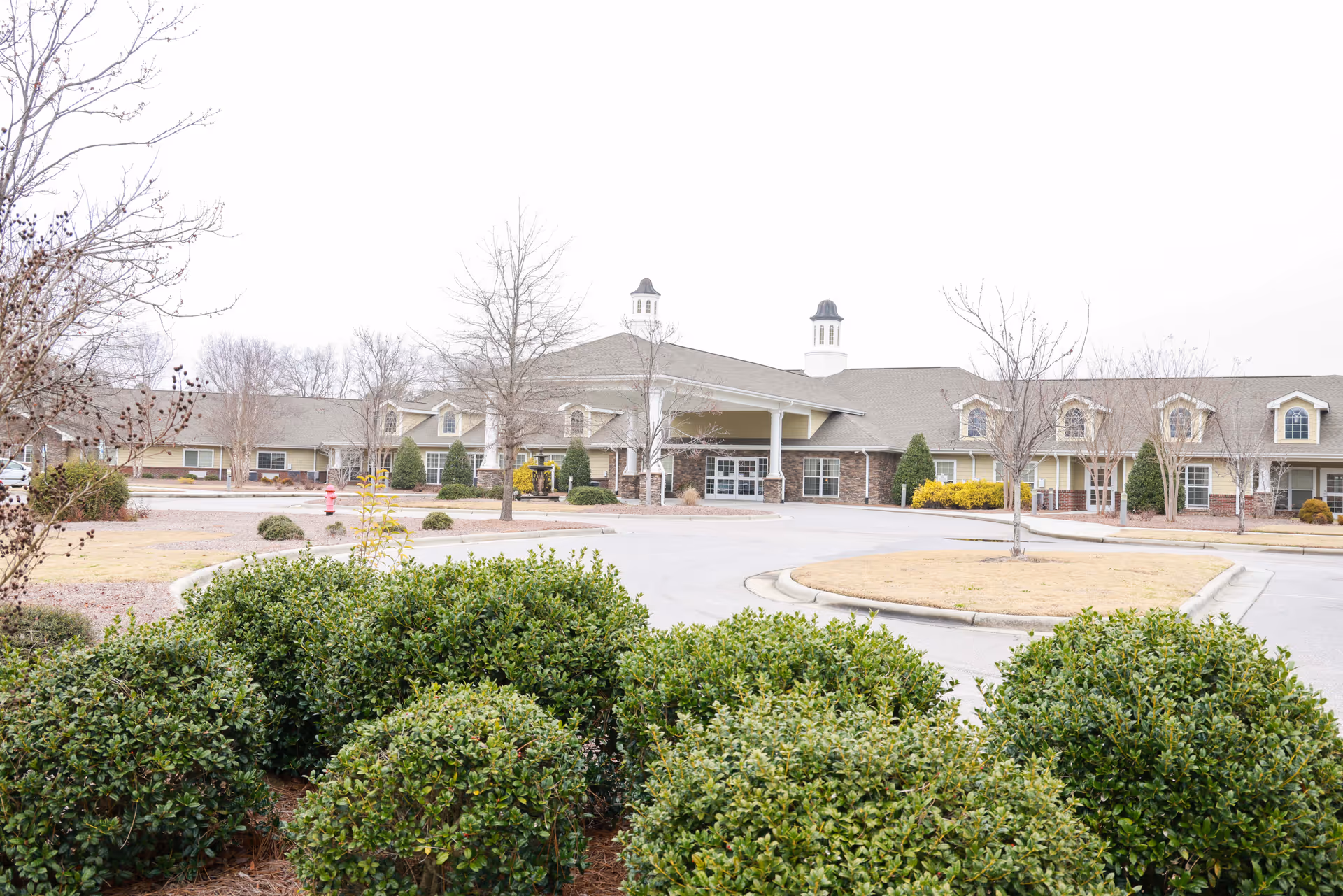 Exterior view of Scottish Pines Rehabilitation and Nursing Center with a circular driveway and entrance canopy.