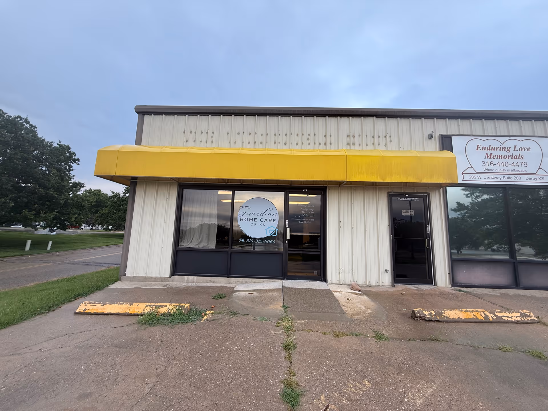 Front view of Guardian Home Care of KS building with yellow awning and glass doors.